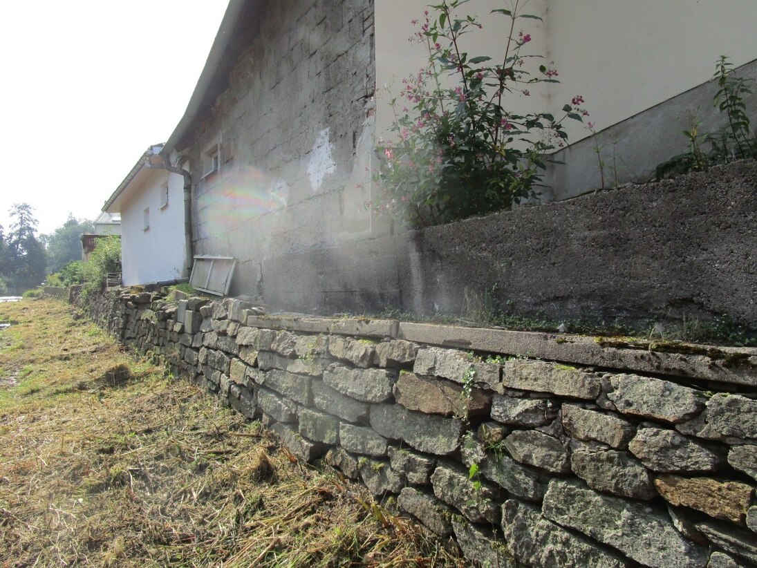 Alte Ufermauer an einem Wohnhaus