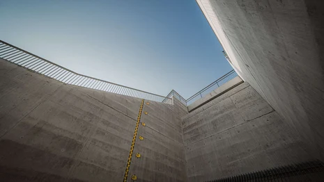 Blick von unten auf ein Stück Mauer eines Hochwasserrückhaltebeckens